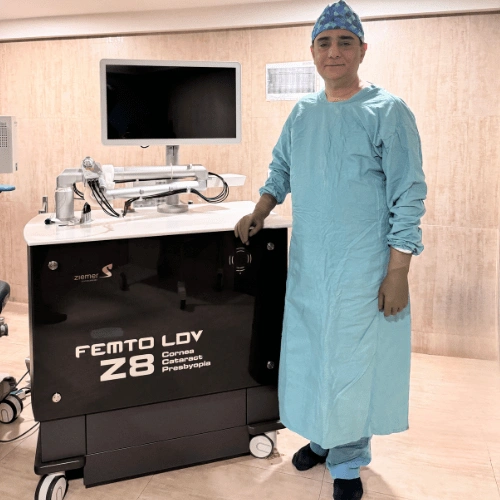 Dr. Kumar standing behind Femto Laser Z8 Machine